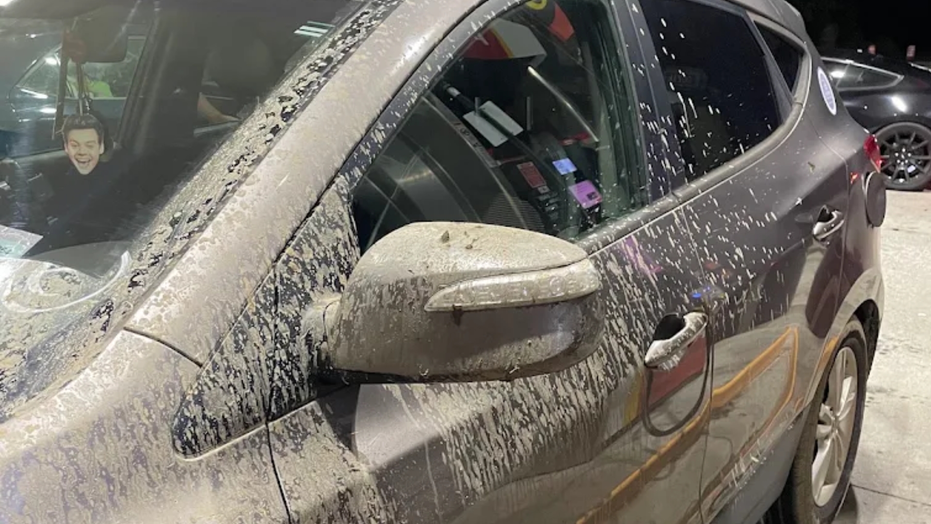 Road spray and dirt accumulating on the lower part of a car